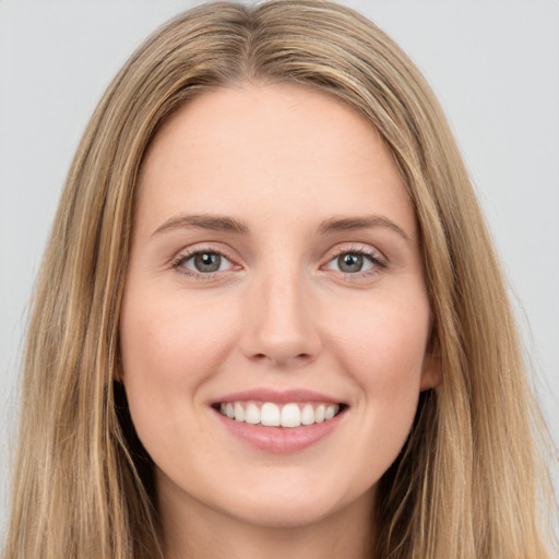 Joyful white young-adult female with long  brown hair and green eyes