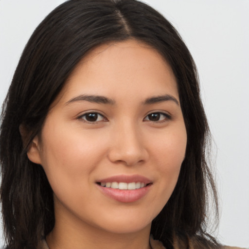 Joyful asian young-adult female with long  brown hair and brown eyes