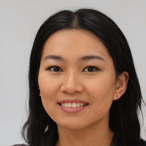 Joyful asian young-adult female with long  black hair and brown eyes