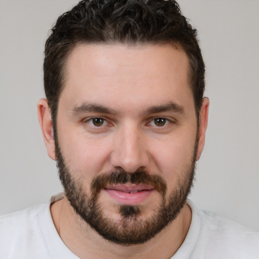 Joyful white young-adult male with short  brown hair and brown eyes