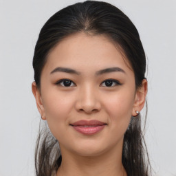 Joyful asian young-adult female with long  brown hair and brown eyes