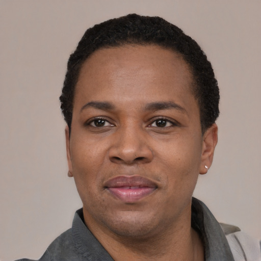 Joyful black adult male with short  black hair and brown eyes