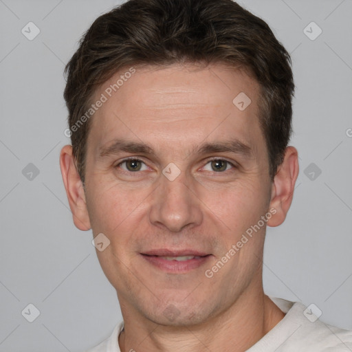 Joyful white adult male with short  brown hair and grey eyes