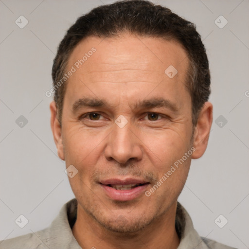 Joyful white adult male with short  brown hair and brown eyes