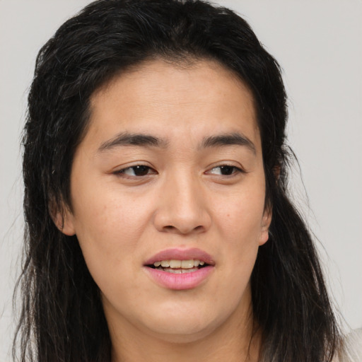 Joyful asian young-adult female with long  brown hair and brown eyes