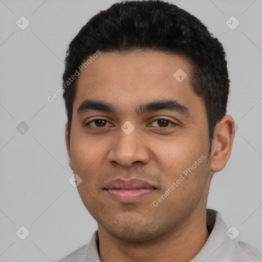 Joyful latino young-adult male with short  black hair and brown eyes