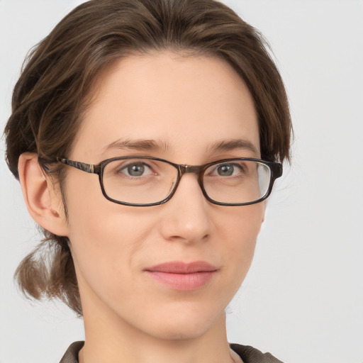 Joyful white young-adult female with medium  brown hair and grey eyes