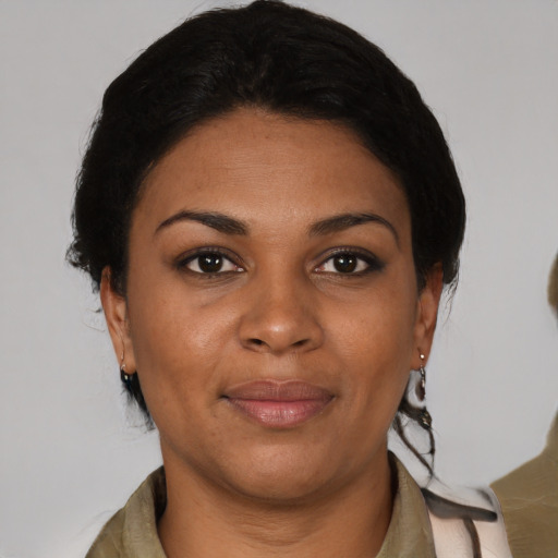 Joyful black young-adult female with medium  black hair and brown eyes