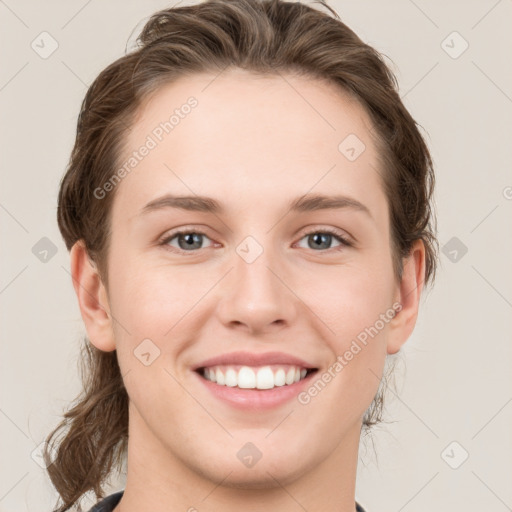 Joyful white young-adult female with medium  brown hair and grey eyes