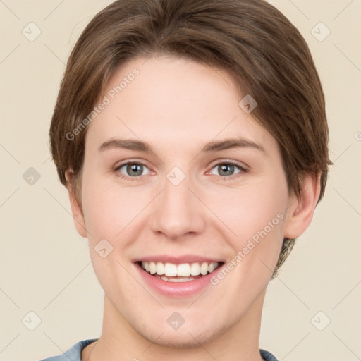 Joyful white young-adult female with short  brown hair and grey eyes