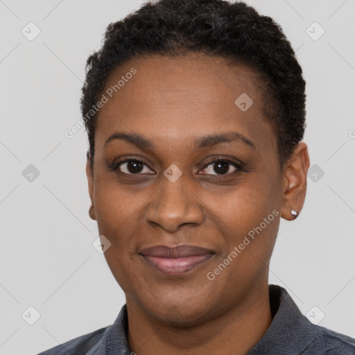 Joyful black adult female with short  black hair and brown eyes