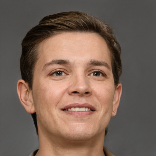 Joyful white adult male with short  brown hair and grey eyes