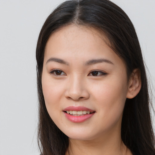 Joyful asian young-adult female with long  brown hair and brown eyes