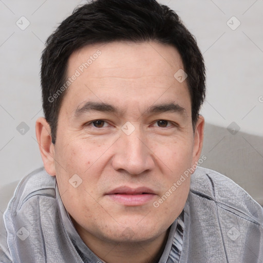 Joyful white adult male with short  black hair and brown eyes