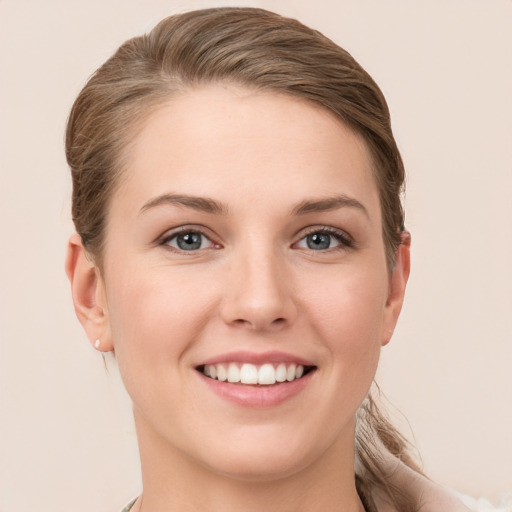 Joyful white young-adult female with short  brown hair and grey eyes