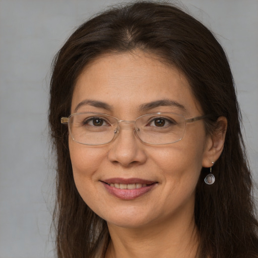 Joyful white adult female with long  brown hair and brown eyes