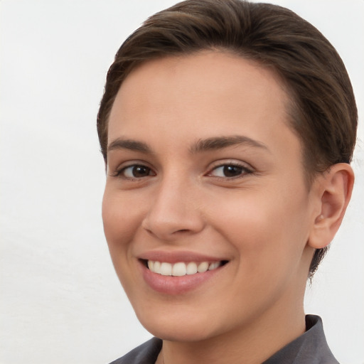 Joyful white young-adult female with short  brown hair and brown eyes