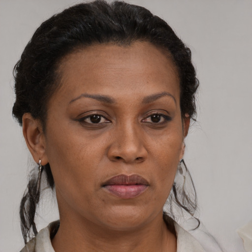 Neutral black adult female with short  brown hair and brown eyes