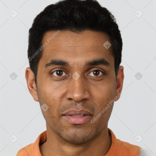 Joyful black young-adult male with short  black hair and brown eyes