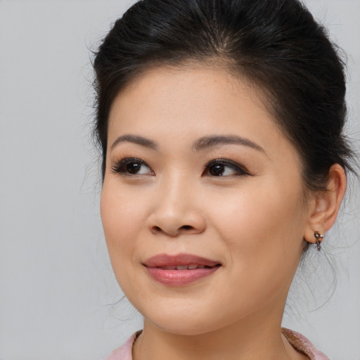 Joyful asian young-adult female with long  brown hair and brown eyes