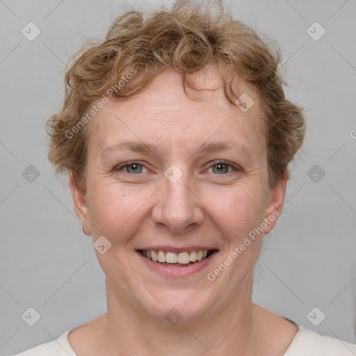 Joyful white adult female with short  brown hair and grey eyes