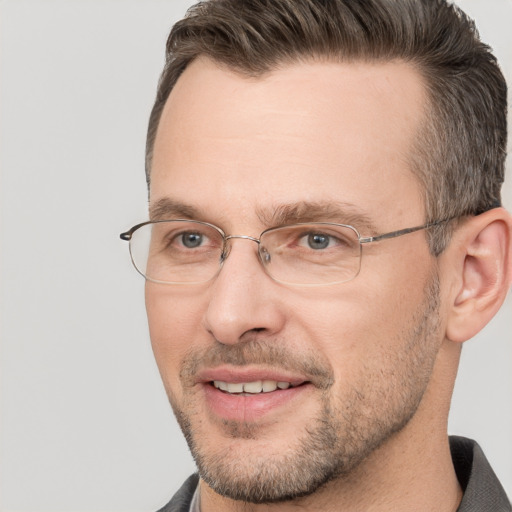 Joyful white adult male with short  brown hair and brown eyes