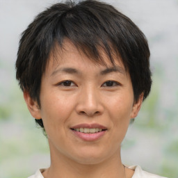 Joyful white adult female with medium  brown hair and brown eyes