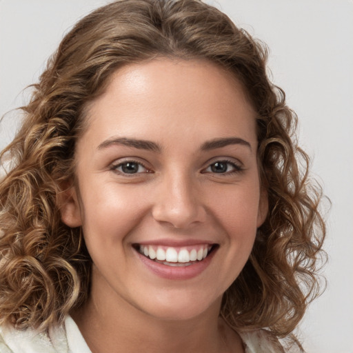 Joyful white young-adult female with medium  brown hair and green eyes