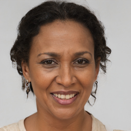 Joyful latino adult female with short  brown hair and brown eyes