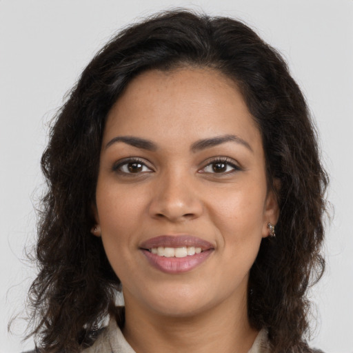 Joyful latino young-adult female with long  brown hair and brown eyes
