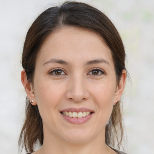 Joyful white young-adult female with medium  brown hair and brown eyes