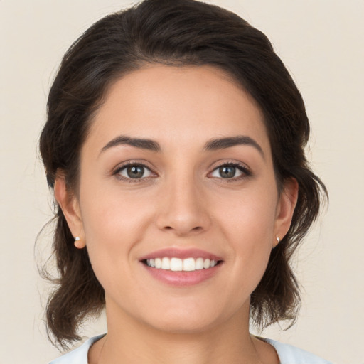 Joyful white young-adult female with medium  brown hair and brown eyes