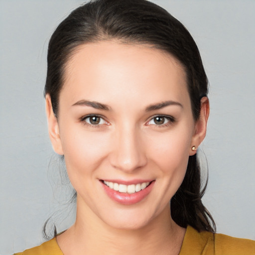 Joyful white young-adult female with medium  brown hair and brown eyes