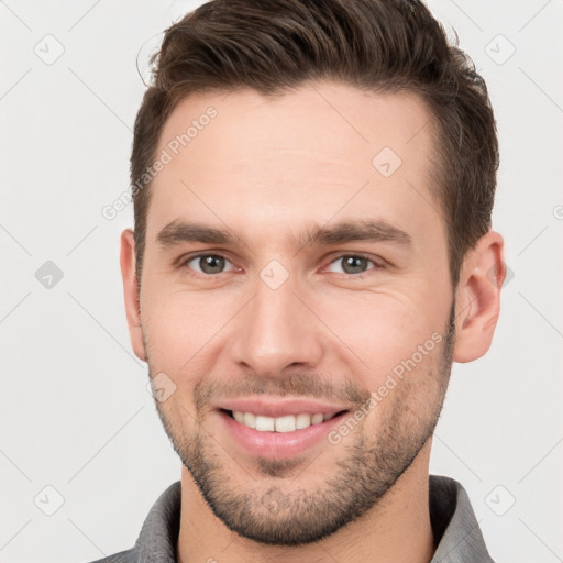 Joyful white young-adult male with short  brown hair and brown eyes