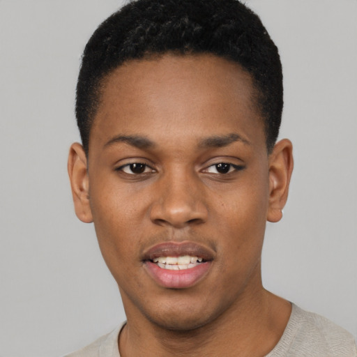 Joyful black young-adult male with short  black hair and brown eyes