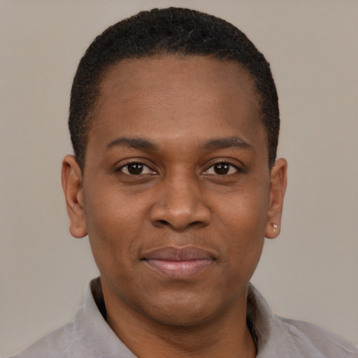 Joyful black young-adult male with short  brown hair and brown eyes