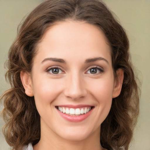 Joyful white young-adult female with long  brown hair and green eyes