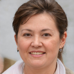 Joyful white adult female with medium  brown hair and brown eyes