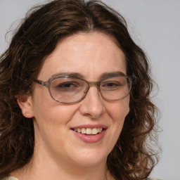 Joyful white adult female with medium  brown hair and blue eyes