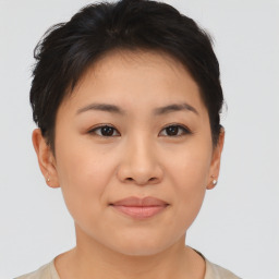 Joyful asian young-adult female with short  brown hair and brown eyes