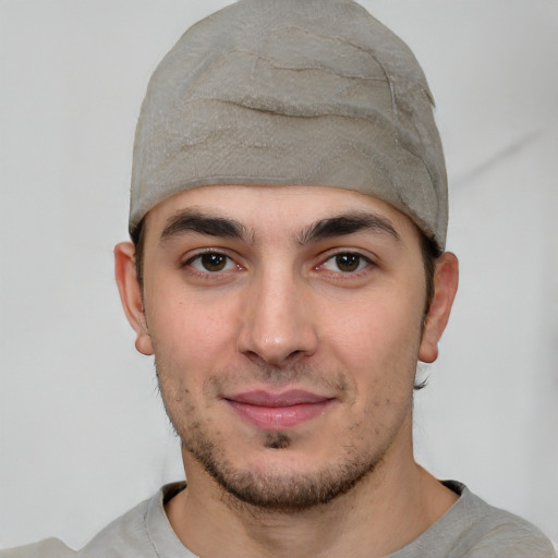 Joyful white young-adult male with short  black hair and brown eyes