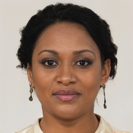 Joyful black adult female with short  brown hair and brown eyes