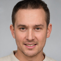 Joyful white young-adult male with short  brown hair and brown eyes