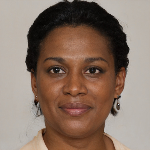 Joyful black adult female with short  black hair and brown eyes