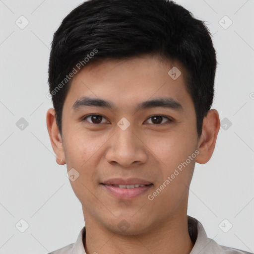 Joyful white young-adult male with short  black hair and brown eyes