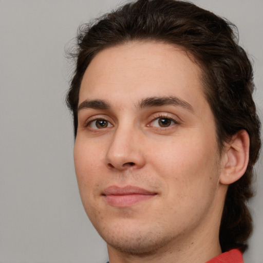 Joyful white young-adult male with medium  brown hair and brown eyes