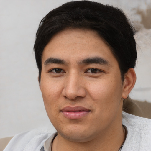 Joyful asian young-adult male with short  black hair and brown eyes