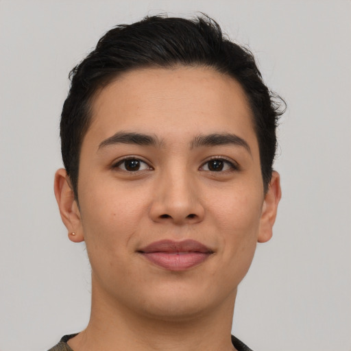 Joyful latino young-adult male with short  brown hair and brown eyes