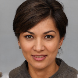 Joyful white adult female with medium  brown hair and brown eyes