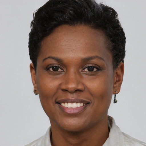 Joyful black young-adult female with short  brown hair and brown eyes